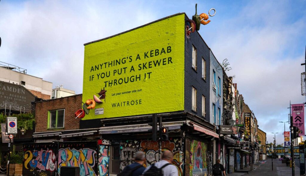 The Waitrose supermarket celebrates summer meals converting advertising fences into skewers