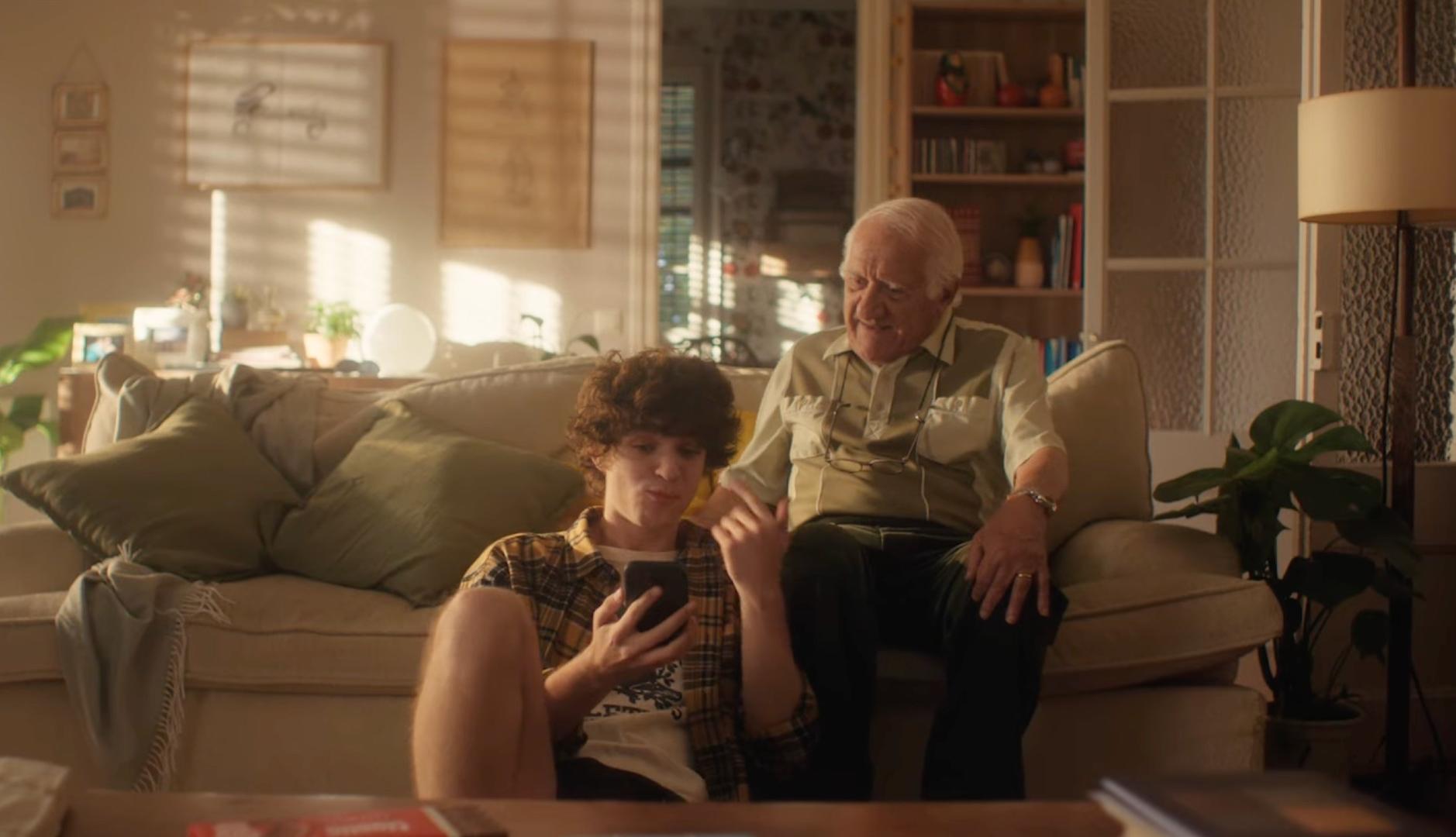 Un abuelo y un nieto sentados en el sofá hablando