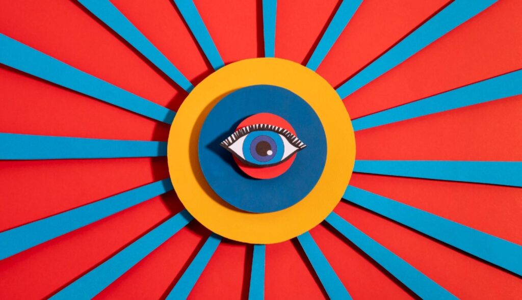Un collage de colores con un ojo en el centro y líneas rojas y azules hacia los extremos